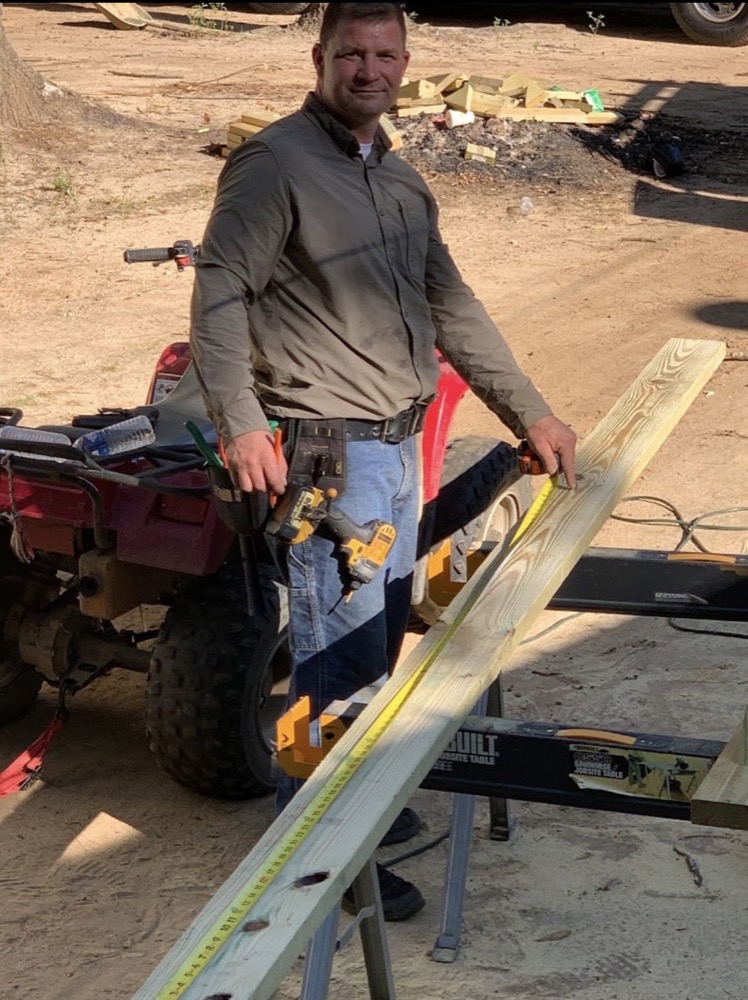 Johnson Roofing Service team member on a job site with tools